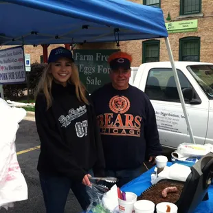a man and a woman standing under a tent