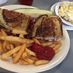 Reuben with fries and potato salad.