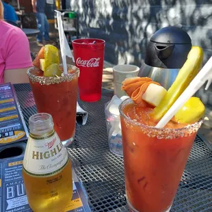a bloody drink and a bottle of beer