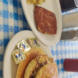 Delicious corned beef hash, well seasoned home fries, and fluffy pancakes