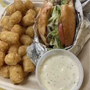 Burger with avocado and a side of tots