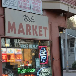 a storefront with neon signs