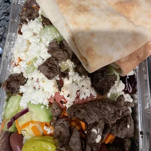 Steak tips on Greek salad