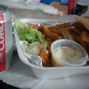Delicious perch sandwich with fries, tartar sauce and a Coke.