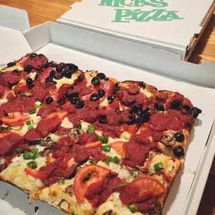 Half and half square pizza. Olives and pepperoni for him and vegetarian for me. Crust wasn&apos;t buttery like pan pizza though.