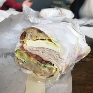Half of a turkey sandwich with fresh motz