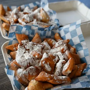 a tray of funnels with powdered sugar