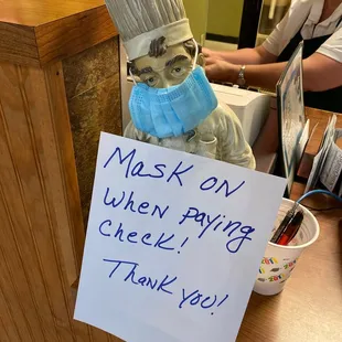 a sign that says mask run when paying check thank you