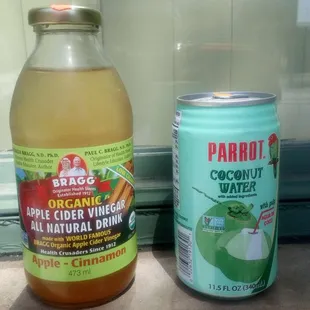a bottle of coconut water and a can of apple cid