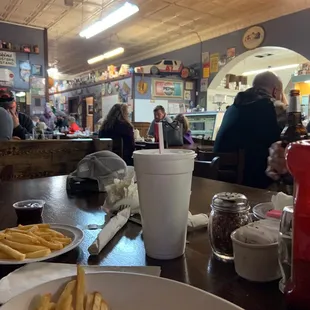 a plate of french fries and a cup of coffee