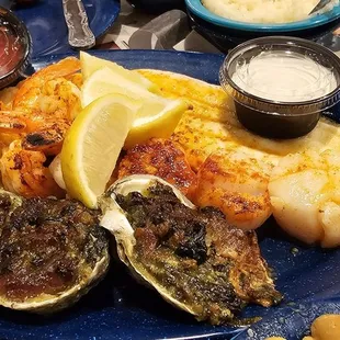 a plate of oysters with a side of mashed potatoes