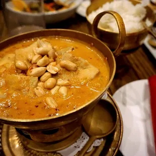 Massaman Curry: potatoes, peanut sauce, coconut milk, massaman curry paste topped with whole roasted peanuts ($19.50 for chicken or pork).