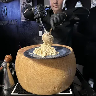 a woman preparing a dish of noodles