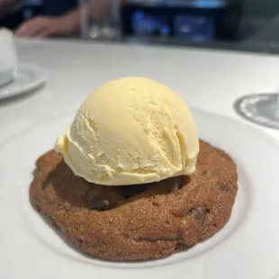 Warm chocolate chip cookie with vanilla ice cream.