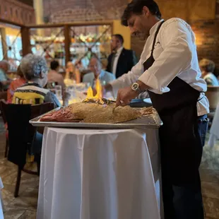 Chef Cristian Pietoso&apos;s Return Dinner - Chef Cristian serving Roasted Salt Encrusted Red Snapper