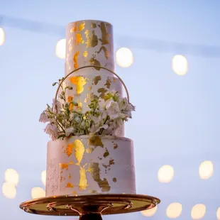 a wedding cake with flowers on top