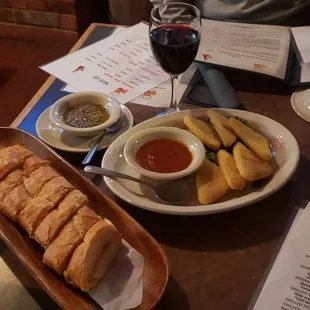 a plate of breadsticks and dipping sauce