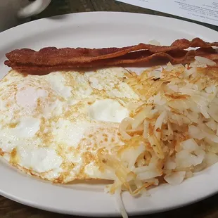 a breakfast of eggs, hash browns and bacon