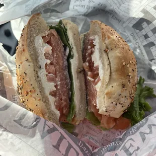 Everything bagel with lox, cream cheese, tomatoes and red onion.