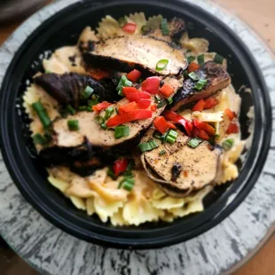 a bowl of pasta with mushrooms and peppers