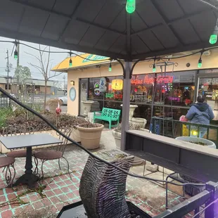 a patio area with tables and chairs