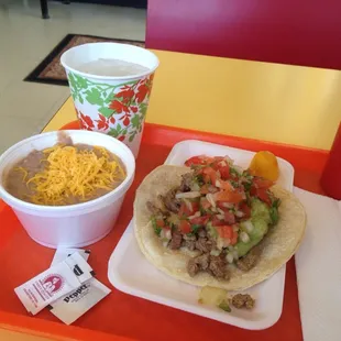 Carne asada taco with a side of beans