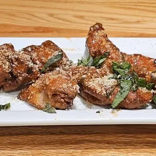 a platter of chicken wings with a side of ranch dressing