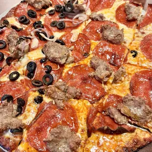 Cheese, sausage, pepperoni with onions and black olives on half