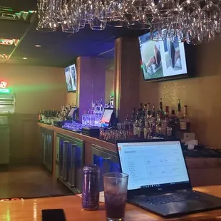 a laptop on a bar counter