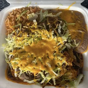 Combo- shredded beef tostada and shredded chicken enchiladas with beans and rice