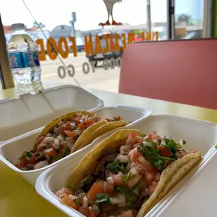 two tacos in a styrofoam container