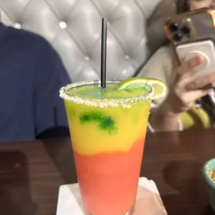 a woman taking a picture of a drink