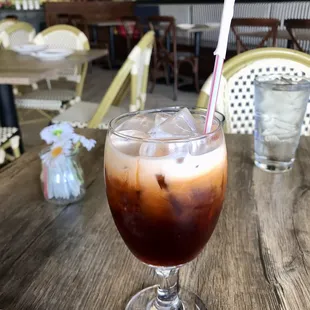 a drink in a glass on a table