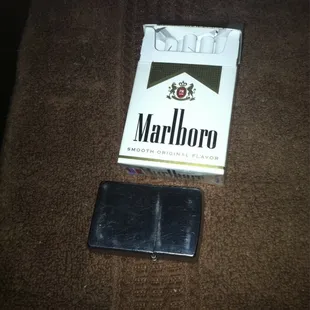 a pack of cigarettes and a cigarette case