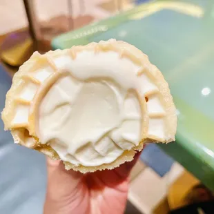 a hand holding a pastry