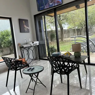 two chairs and a table with a television in the background