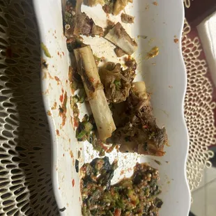 $68 dollar plate of raw crunchy okra soup with goat bones served as Meat Pepper Soup