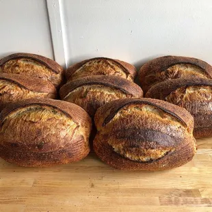a pile of bread on a wooden table
