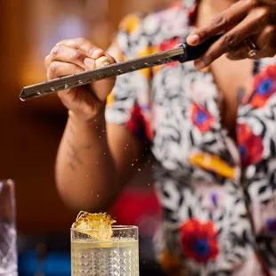 a woman preparing a cocktail