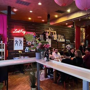 people sitting at tables in a restaurant