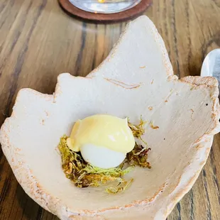 a bowl of food on a wooden table