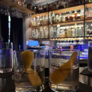 two glasses of water with lemon wedges