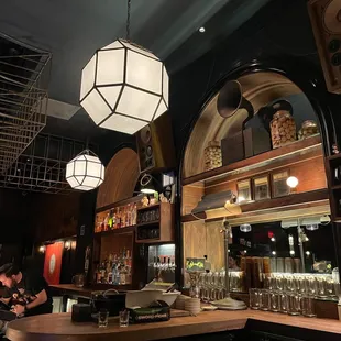 a view of a bar with a lot of glasses on the counter