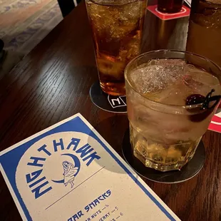 a drink and a menu on a table