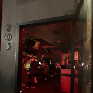 people sitting at tables in a bar