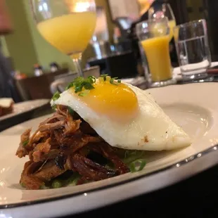 a plate of food with a fried egg on top