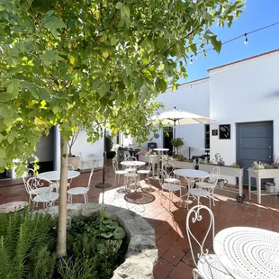 a patio area with tables and chairs