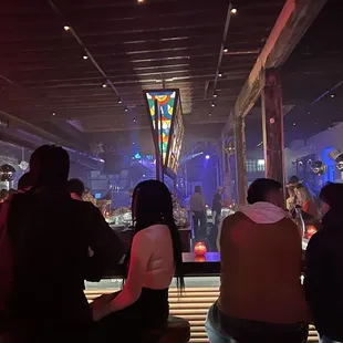 a group of people sitting at a bar