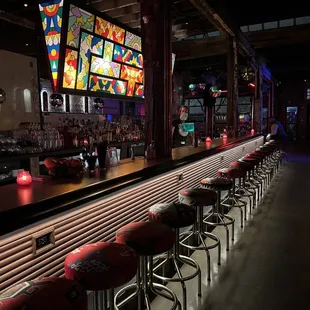 a bar with red stools