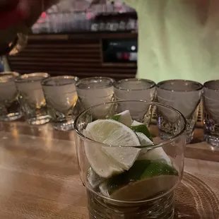 a person pouring a drink into a glass